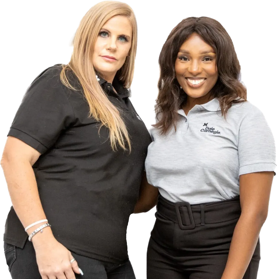 Two Dale Carnegie team members in branded polo shirts
