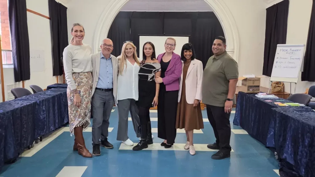 Dale Carnegie graduates with their trainers on graduation day