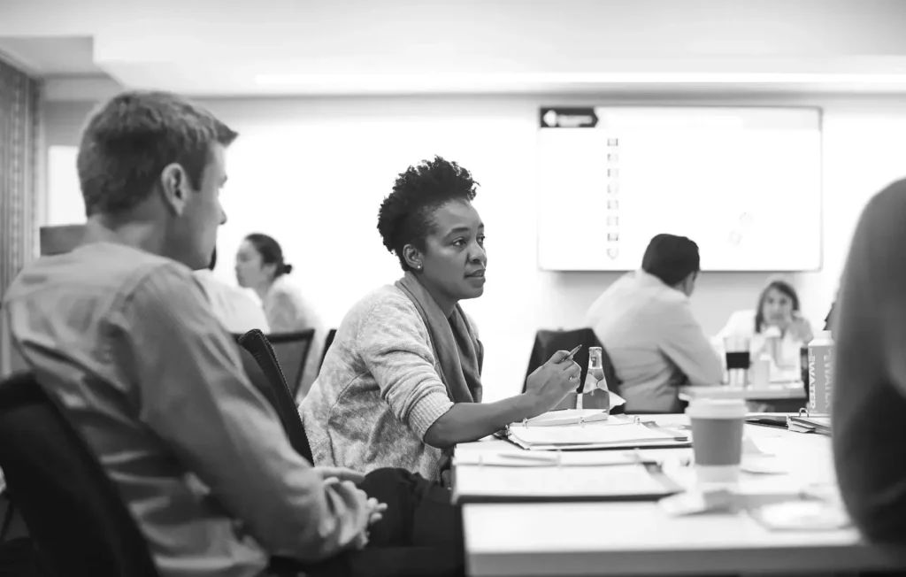 Colleagues in a lively discussion during a Dale Carnegie training session