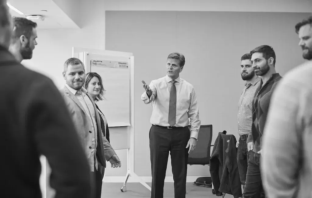A trainer presenting to a group of professionals